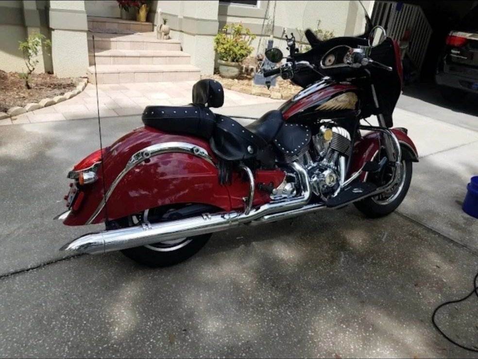 A red Indian Chieftain motorcycle on a driveway