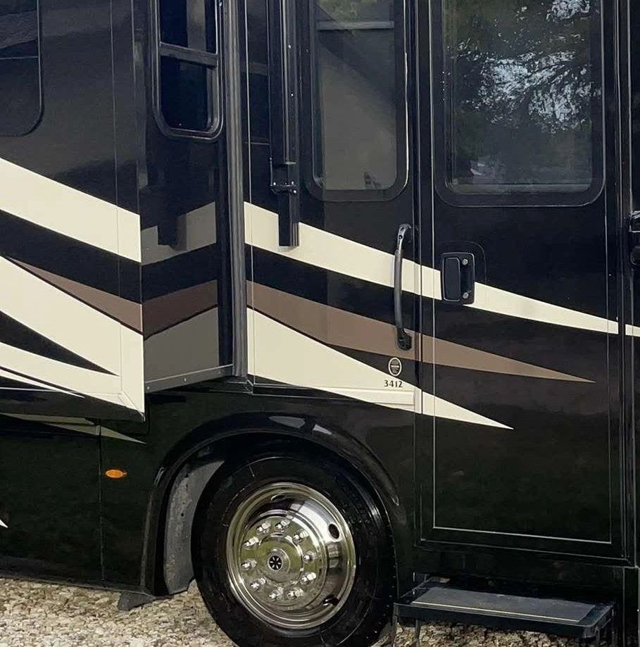 A motorhome door and wheel, detailed close in